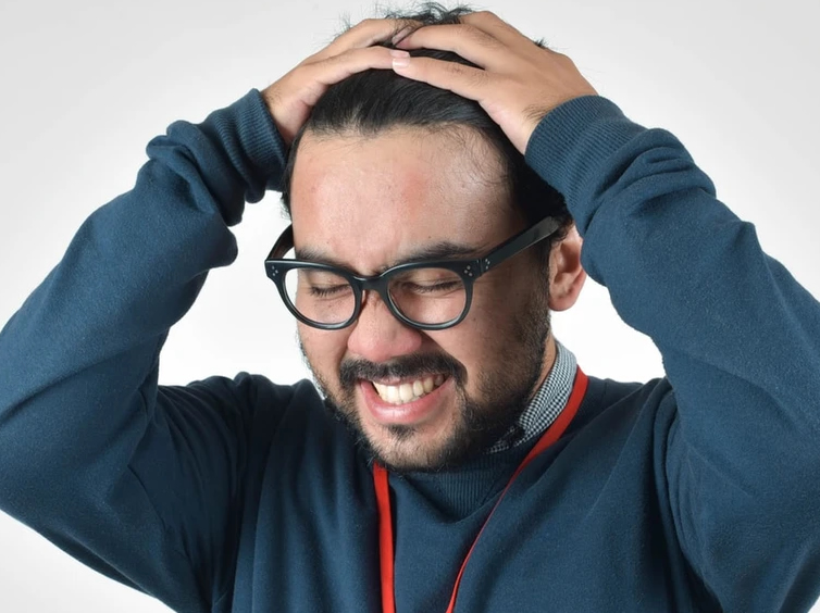 Frustrated man holding head